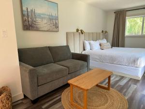 a living room with a couch and a bed at Lakeside Villa in Penticton