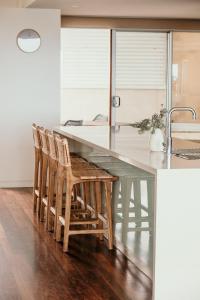 a kitchen with a glass table and chairs at Hearns Beachside Villa 9 in Port Fairy
