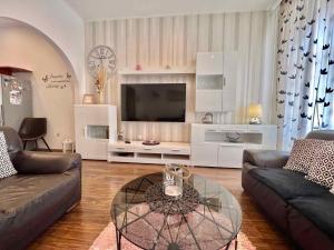 a living room with a couch and a tv at Holiday home in Crikvenica 42922 in Crikvenica