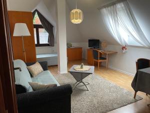 a living room with a couch and a table at Diamant Apartmanház in Eger