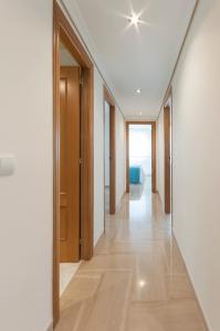 a hallway of a house with white walls and wooden doors at Ag Aiguablava in Gandía