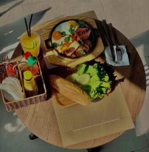 a wooden table with a plate of food on it at SOLEIL HOSTEL in Hue