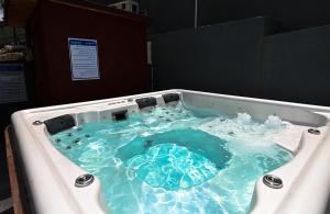 a bath tub with blue water in it at YalaRent Liri Resort - a beautiful resort complex in Tiberias in Tiberias