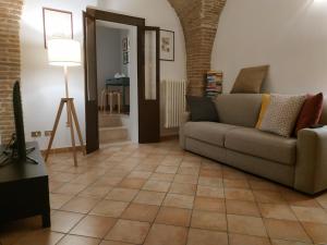 a living room with a couch and a floor at Bed and Breakfast In Piazza Orazio in Venosa
