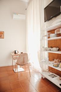 a kitchen with a table and a chair in a room at Hotel Torino in Brindisi