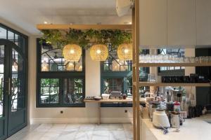 a kitchen with a counter and some windows at CASA LIVING SENOPATI in Jakarta