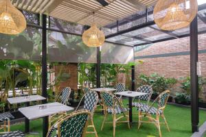 a patio with tables and chairs and lights at CASA LIVING SENOPATI in Jakarta