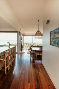 a kitchen and dining room with a table and chairs at Hearns Beachside Villa 9 in Port Fairy
