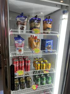 a refrigerator filled with lots of drinks and drinks at Eight Days Boutique Hotel - Impian Emas in Skudai