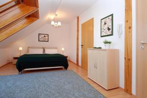 a bedroom with a bed with a green blanket at Ferienwohnung Bisch in Görlitz