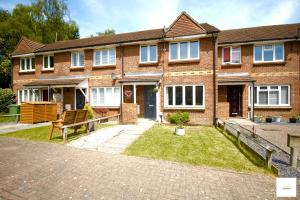 a brick house with a bench in front of it at Camberley Spacious and Comfy 3 Bedroom Home, Next to Frimley Hospital with Parking in Frimley