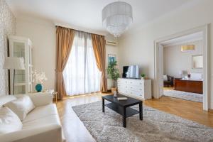 a living room with a white couch and a table at GDE Károly Apartmant in Budapest