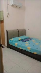 Кровать или кровати в номере INAPAN SRI AMAN ANAK BUKIT ALOR SETAR