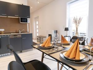 a kitchen and dining room with a table and chairs at FiMo-Haus in Nagel