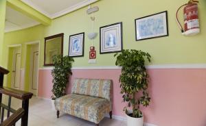 a waiting room with a chair and potted plants at Cala Bona y Mar Blava in Ciutadella