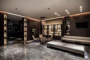 a lobby of a hotel with a table and chairs at The Royal Park Hotel Kyoto Sanjo in Kyoto