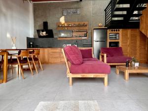 uma cozinha com duas cadeiras roxas e uma mesa em LINDT - Bali Invest Club em Dalung