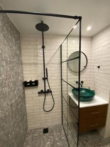 a bathroom with a shower and a green sink at Piraeus cozy appartment rental in Piraeus