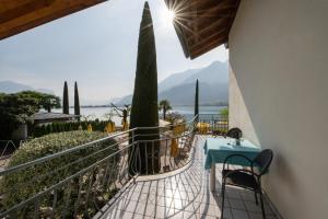 a balcony of a house with a table and chairs at PENSION KLUGHAMMER in Caldaro