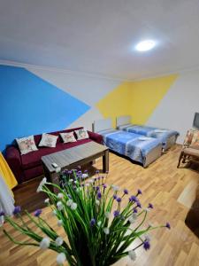 a living room with a couch and a table at Guesthouse Gorgasali 57 in Batumi