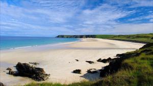 Blick auf einen Strand mit Felsen und dem Meer in der Unterkunft Westview Accommodation in Stornoway