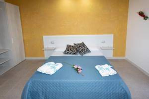 A bed or beds in a room at B&B L'Oasi