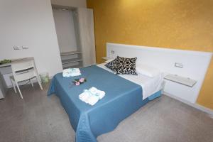 A bed or beds in a room at B&B L'Oasi