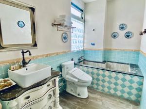a bathroom with a sink and a toilet at 法國小古堡- 包棟-Chateau de France in Wujie