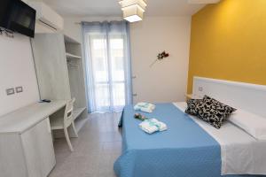 A bed or beds in a room at B&B L'Oasi