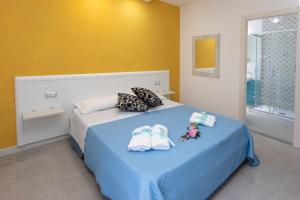 A bed or beds in a room at B&B L'Oasi