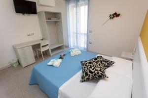 A bed or beds in a room at B&B L'Oasi