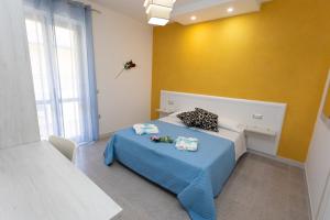 A bed or beds in a room at B&B L'Oasi