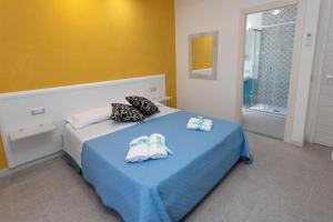 A bed or beds in a room at B&B L'Oasi