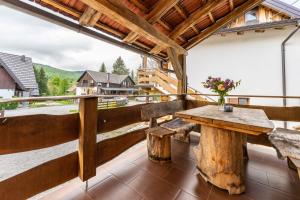 een houten tafel op een balkon met uitzicht bij B&B Plitvica Lodge in Plitvica selo