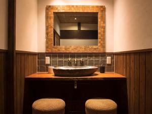 uma casa de banho com um lavatório com um espelho e 2 bancos em Nantan - House - Vacation STAY 84722 em Ōno