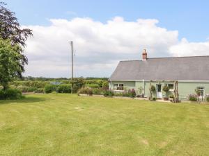 a house with a yard in front of it at Nash Lodge in Pembroke Dock