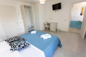 A bed or beds in a room at B&B L'Oasi