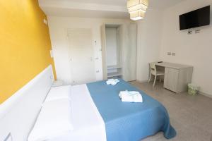 A bed or beds in a room at B&B L'Oasi