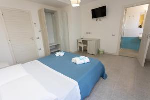 A bed or beds in a room at B&B L'Oasi