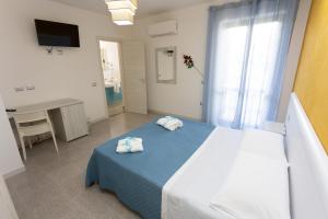 A bed or beds in a room at B&B L'Oasi