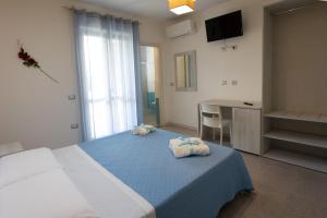 A bed or beds in a room at B&B L'Oasi