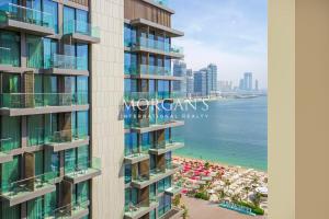 a view of the ocean from the balcony of a building at Stunning Brand New 2 BR in Fairmont in Dubai