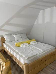 a bed with two pillows on it in a room at Vila Perisic in Kaludjerske Bare