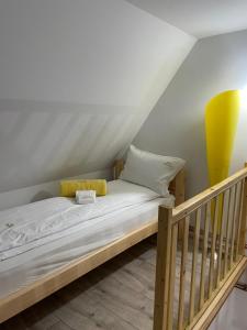 a bed in a room next to a staircase at Vila Perisic in Kaludjerske Bare