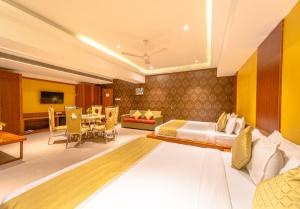a hotel room with a bed and a dining room at Shamrock Greens by Jardin Hotels in Dharmpura
