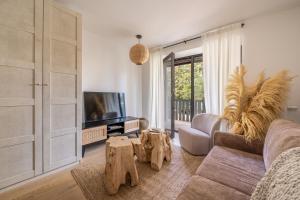 a living room with a couch and a tv at Jurmala seaside apartment with balcony in Jūrmala