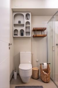 a bathroom with a toilet and a walk in shower at Jurmala seaside apartment with balcony in Jūrmala