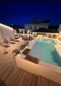 a swimming pool on top of a building at night at Palazzo Firenze in Naples