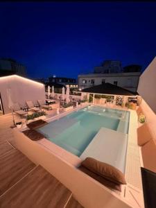 a swimming pool on the roof of a building at Palazzo Firenze in Naples