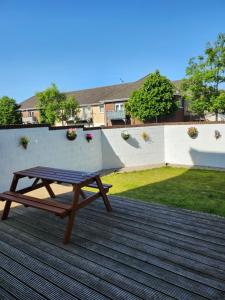 a picnic table sitting on top of a deck at Park View room with free minibar tea&coffee in Dublin